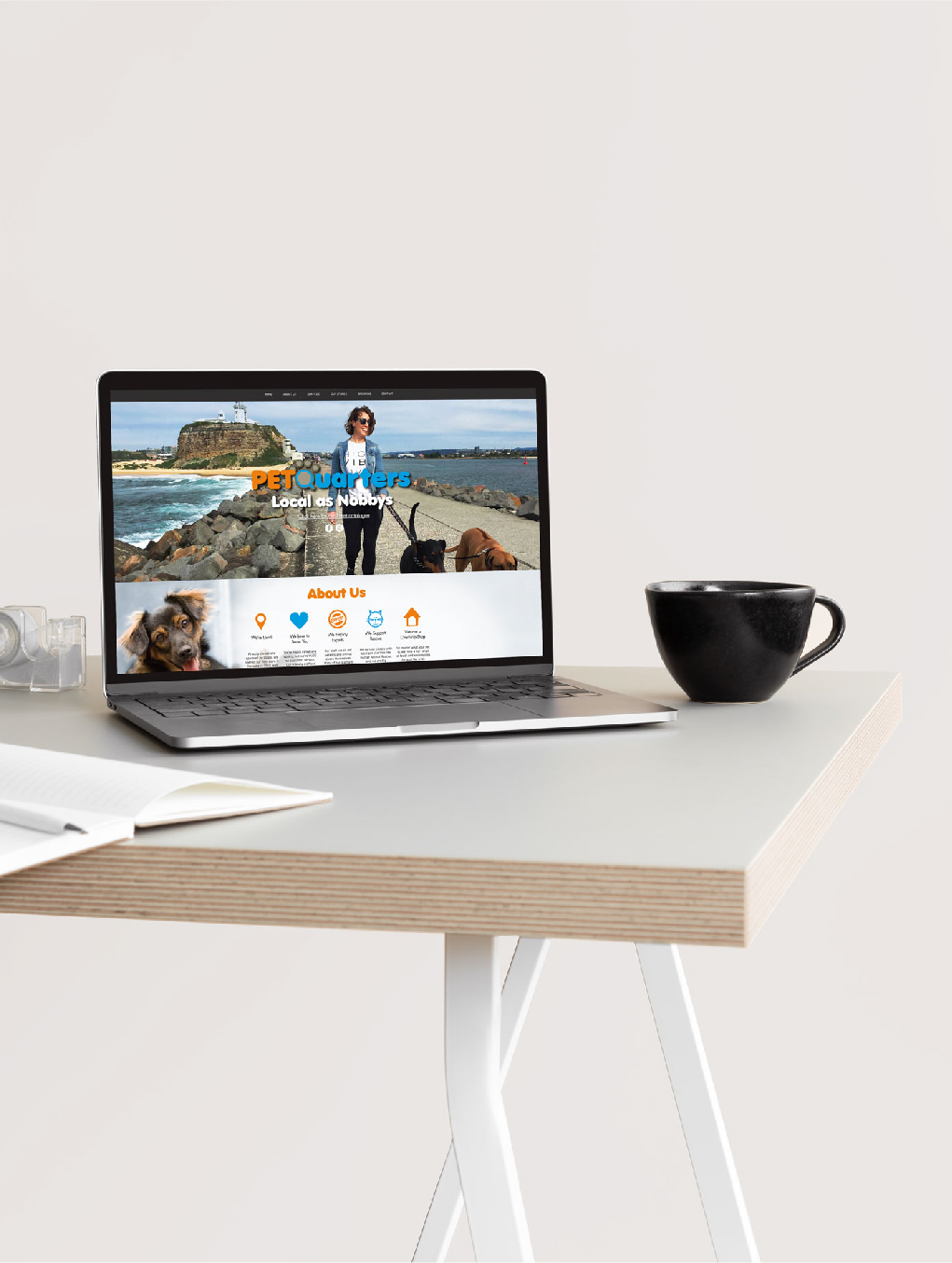 Image of laptop on desk showing PetQuarters website