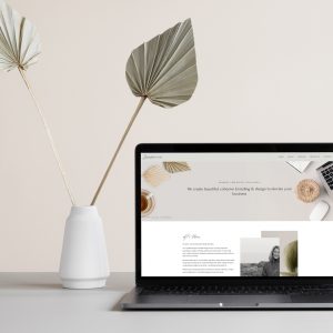 Image of laptop on desk with vase and flowers