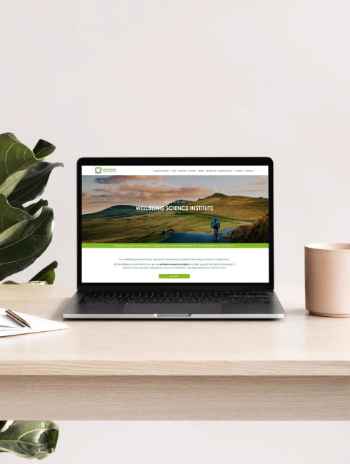 Image of computer on desk showing new client website design