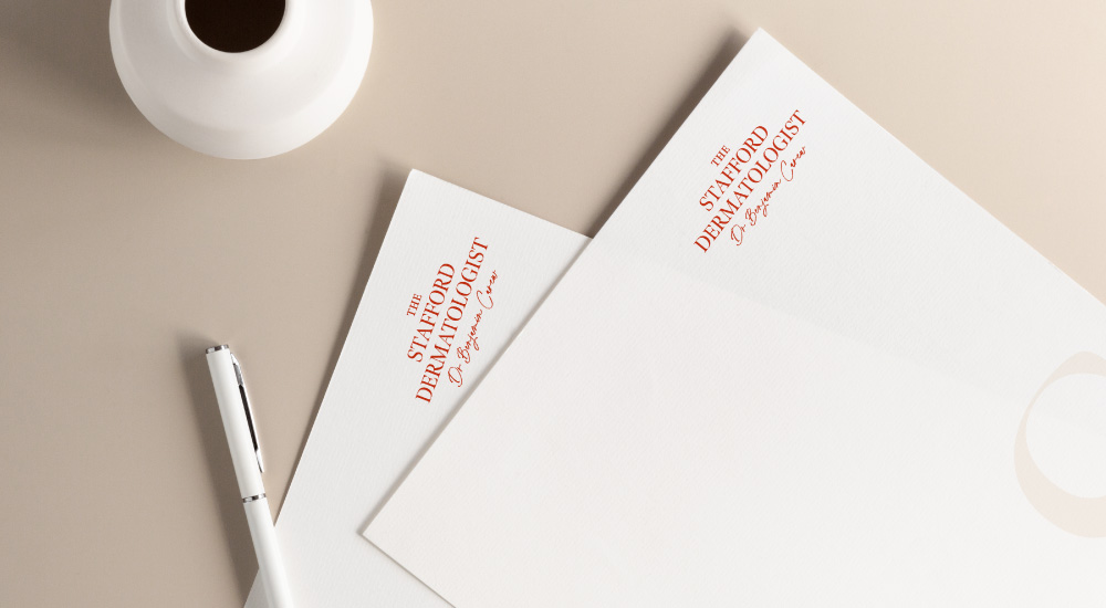 2 letterheads sitting on cream desk with pen
